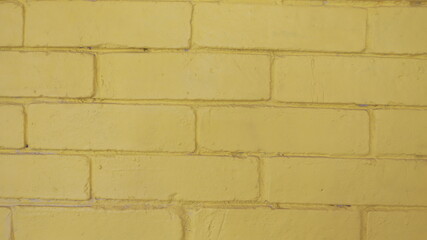 Fototapeta premium Pared amarilla de ladrillos pintado, textura rustica