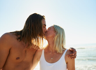 To truly love is to truly live. Shot of an affectionate young couple kissing each other at the beach.