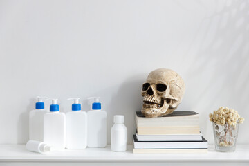 White bottles with a blue dispenser with shampoo, conditioner, cream and liquid soap stand on a...