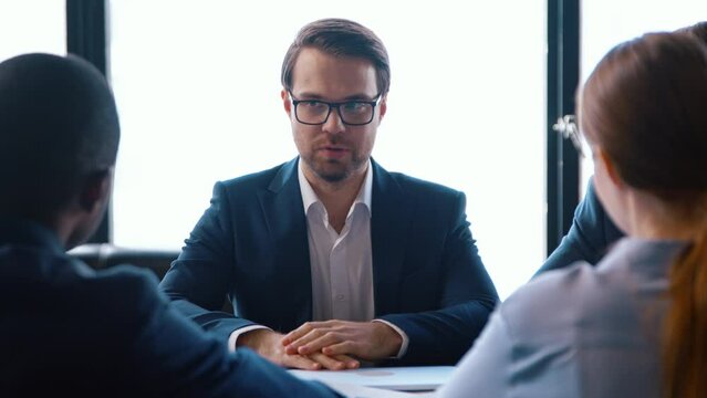 Young business people in a suit interviewing a team at the desk