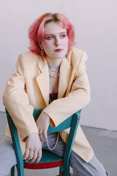 Young Fashion Stylish Woman Sitting At Studio, Bright Make Up And Colored Hair