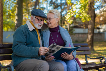 Fototapeta premium Happy moments, adult parents admiring photos in family album remembering youth