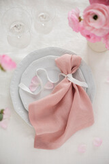 Elegant pink linen napkin on the white dish