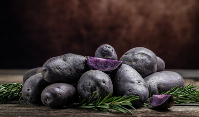 Raw purple sweet potato food . Fresh potatoes in an old sack on wooden background. Batata potato. vegan food ingredient. banner, menu, recipe place for text, top view
