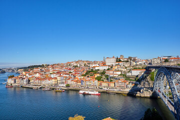 Fototapeta na wymiar The old town of Porto with the river Douro and the famous iron bridge on a sunny day