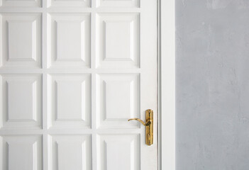 Closed door with golden doorknob and lock