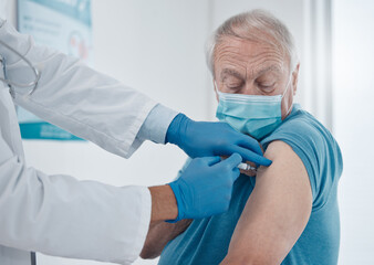 Getting the jab. Cropped shot of a handsome senior man getting his covid 19 vaccine. - obrazy, fototapety, plakaty