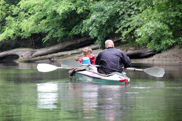Man and woman rafting down the river in a kayak