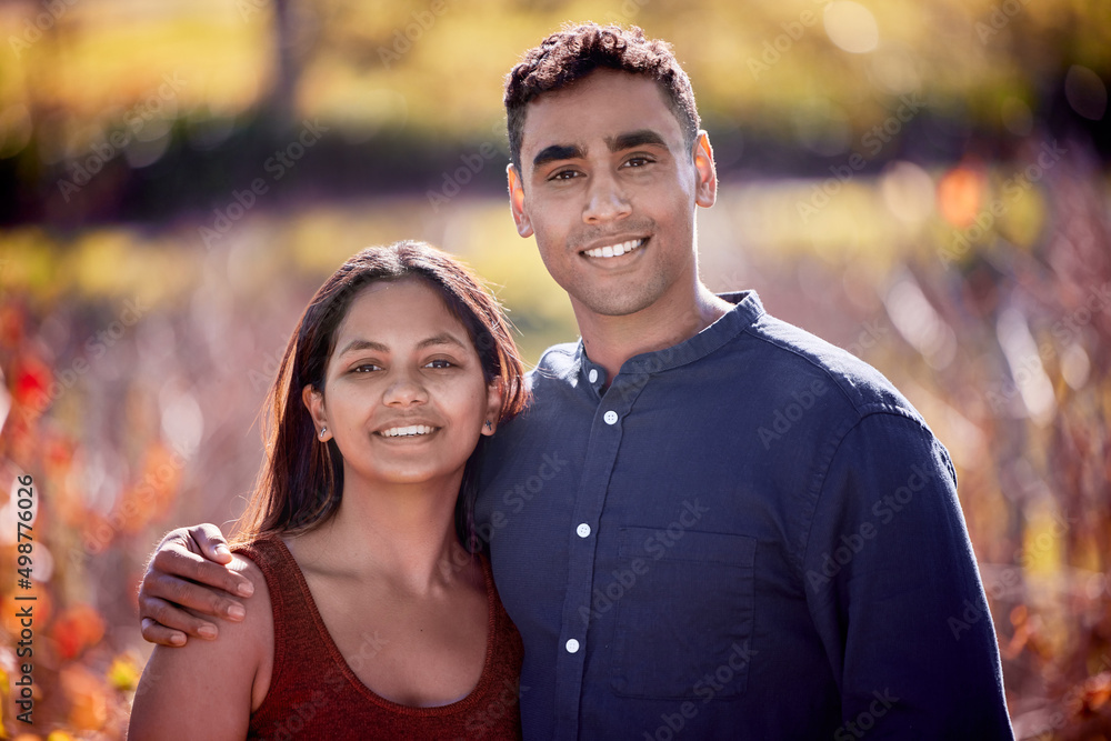 Poster id go anywhere in the world with you. shot of a young couple having a date on a wine farm.