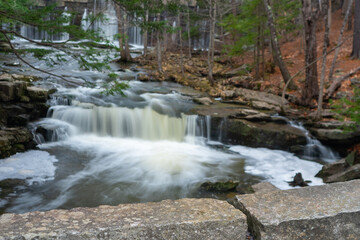 Fototapeta premium Granite blocks in foreground with long exposure cascade in background