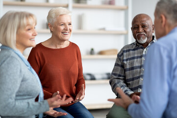 Excited multiethnic elderly people attending group therapy session