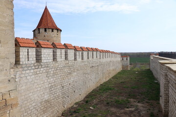 Fototapeta na wymiar Ancient fortress of the port city, stone walls, isolated knight elements