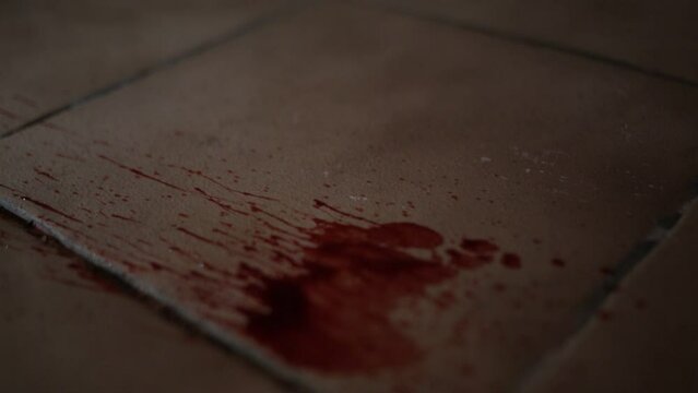 Blood spray onto tiled floor