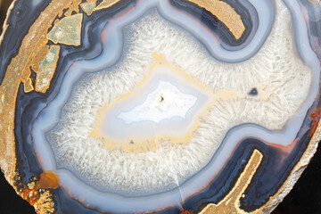 Natural luxury colorful background. A cut of a semi-precious stone. The texture of the mineral. A piece of agate ore. Multicolored. Fantastic beauty crystal. Material for jewelers and sculptors. Art