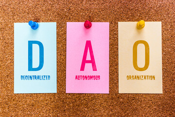 Conceptual 3 letters keyword DAO (Decentralized Autonomous Organization) on multicolored stickers...
