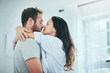 We look forward to spending time together. Shot of a young couple sharing an intimate moment in their bedroom.
