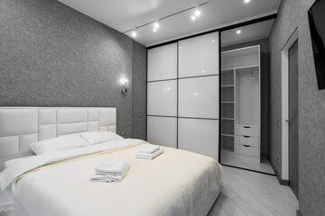 Master bedroom with sliding wardrobe and balcony door. Elegant and comfortable hotel bedroom...