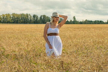 young beautiful woman in a wheat field