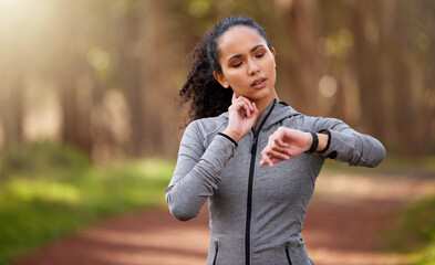 That run did exactly what it was supposed to do. Shot of a woman feeling her pulse while checking her watch.