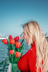 woman with a bouquet of red tulips 