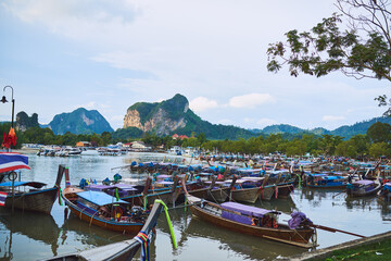 Travel the traditional way. Shot of traditional wooden boats resting on a beach in Thailand.