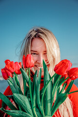 woman with a bouquet of red tulips 