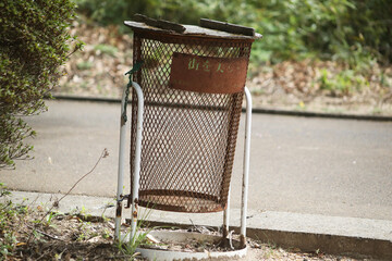 An old trash can in the park