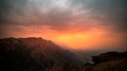 Dramatic sunset view over the mountain. colorful panoramic nature scenery shot from Munnar Kerala