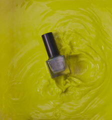 Nail varnish splash image, with nail varnish being splashed in green paint. 