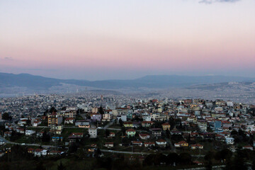Fototapeta na wymiar Izmir city view. Pink sky and mountains above city