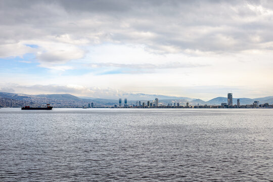 City view of Izmir from ferryboat. Cold grey winter Aegean sea.