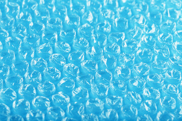 Packing bubble wrap for parcels on a blue background in full screen