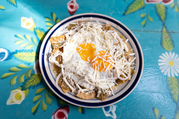 Dish with fried eggs and nachos
