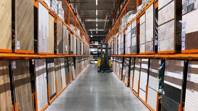 Floor materials - laminate, artificial granite, floor tiles are displayed in the warehouse