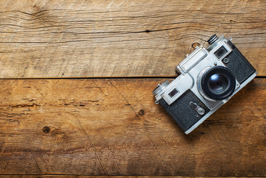 old photo camera on a wooden background