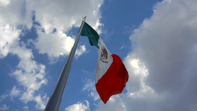 Big Mexican Flag Floating on the wind in slow motion. Close up.
