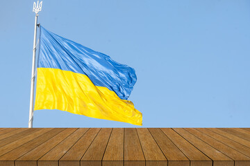 Ukraine flag on backgrounds textures tabletop, wooden board.