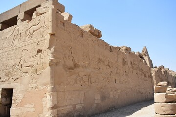 Carvings and hieroglyphics on the exterior wall, at the Karnak Temple Complex in Luxor, Egypt.