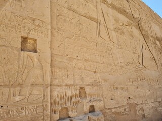 Carvings and hieroglyphics on the exterior wall, at the Karnak Temple Complex in Luxor, Egypt.