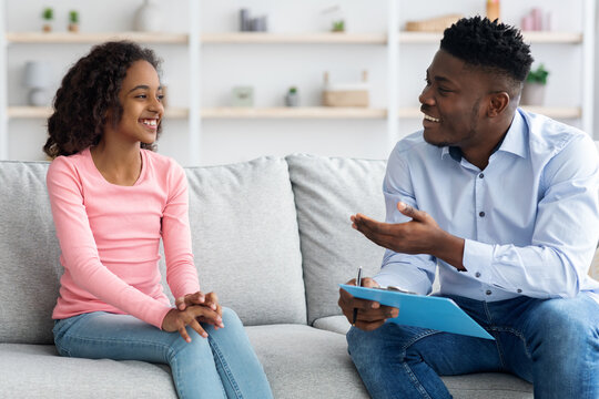 Pretty black girl teenager attending therapy session with psychologist