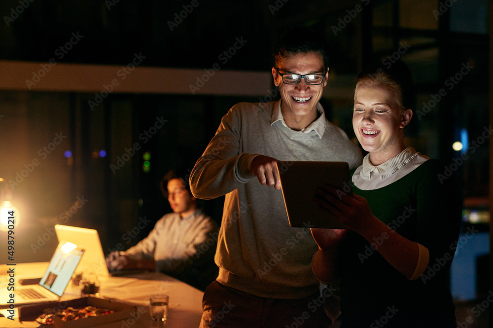 Poster all they need packed into one handy device. shot of businesspeople working together on a digital tab