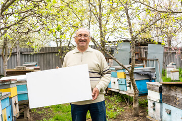 Smiling man holding a canva in garden