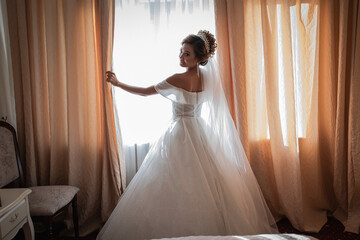 Bride gathering at the hotel. Bouquet of flowers and veil. Loving couple at an international...
