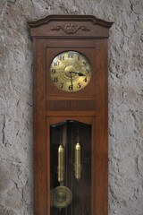 An old clock against a ruined wall ...