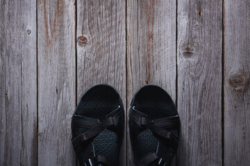 Summer sport sandals on wooden bottom. Accessory. Copy space. Selective focus.