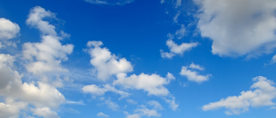 Blue sky with beautiful white clouds. Wide photo.