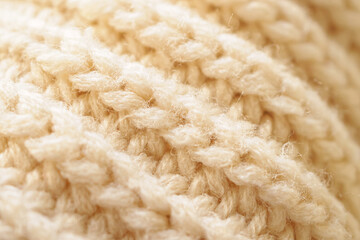 closeup beige knitted woolen fabric texture background