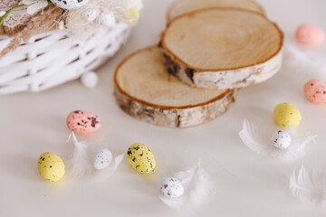 There are a white basket and three woods on the white table.