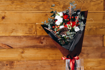 There is a bouquet on the wood-brown background.