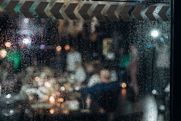 wet window with drops on the glass on a rainy day